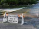 Road Closed sign due to high water in front of water crossing over the road
